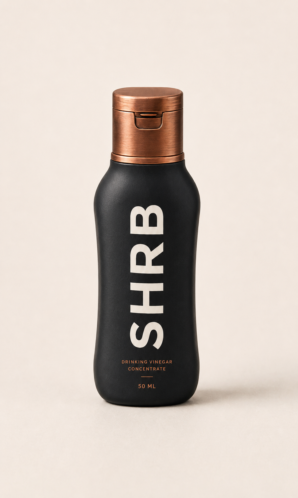 Compact SHRB drinking vinegar concentrate bottle with matte black body and copper one-handed locking cap